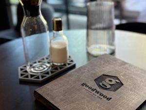 a table with a bottle of soap and a book at Goodwood Lodge am See in Scharbeutz +11 photos