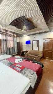 a bedroom with a large bed and a tv on the ceiling at Hotel New Royal Plaza in Chandīgarh