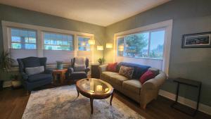 a living room with a couch and two chairs and a table at Park Haven on the Hill in Astoria, Oregon