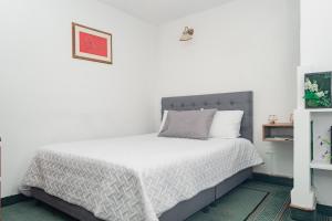 Postel nebo postele na pokoji v ubytování Innovar Casa Hostal