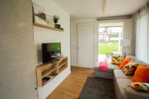 a living room with a couch and a television at Sopela Kosta Fun in Sopelana +12 photos