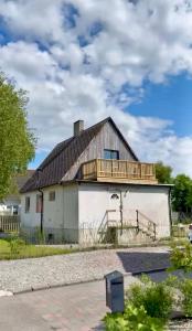a house with a deck on top of it at Hus med stor trädgård i lugn miljö nära havet in Bunkeflostrand