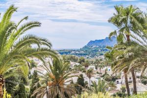 a view of a town with palm trees and mountains at Apt B Algemesi Moraira in Moraira