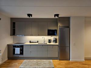 a kitchen with a stainless steel refrigerator and a sink at There is no planet like E Planet in Järfälla