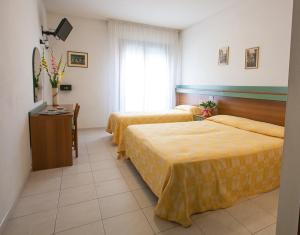 Postel nebo postele na pokoji v ubytování Hotel Grand Prix