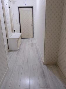 a hallway with a bathroom with a sink and a door at Уютная квартира ЖК Orynbor towers in Astana
