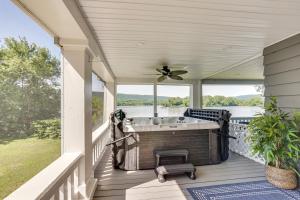 a hot tub on a porch with a view of the water at Steps to Susquehanna River Hot Tub Hideaway! in Dauphin