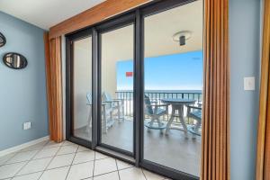 a sliding glass door with a view of the ocean at Phoenix 2 Unit 2034 in Orange Beach