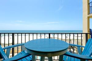 a table and chairs on a balcony with the beach at Phoenix 2 Unit 2034 in Orange Beach