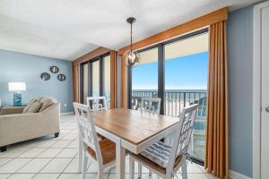 a dining room with a table and views of the ocean at Phoenix 2 Unit 2034 in Orange Beach +37 photos