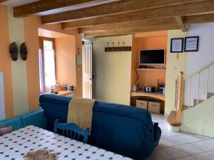 a living room with a blue couch and a table at Gîte Chez Charlot in Chanaz