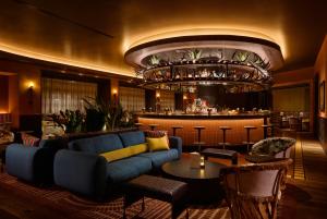a living room with a couch and a bar at Fairmont Chicago Millennium Park in Chicago