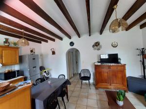 a living room with a table and a kitchen at Maison de vacances en Corrèze in Saint-Pardoux-lʼOrtigier +11 photos