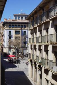 an apartment building with a courtyard with tables and chairs at Apartamentos Turísticos Río Gallego (Apartamento Huesca) in Huesca