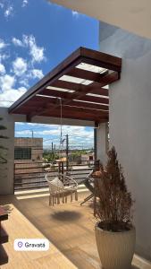 a patio with awning on top of a building at Casa villa Gravatá in Gravatá