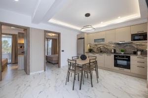 a kitchen with a table and chairs in a room at Valianos Studios - Luxury Apartment in Alikanas