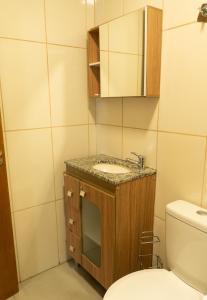 a bathroom with a sink and a toilet at Casa João e Maria - CANELA in Canela