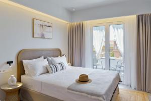 a bedroom with a bed with a hat on it at Villa Magda Maria in Pefkochori
