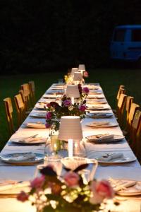 a long table with plates and lamps and flowers on it at VILLA MEGUINELLE in Grand-Fougeray +40 photos