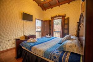 Voodi või voodid majutusasutuse Hotel Caxa Real toas