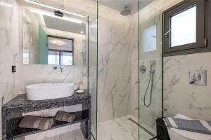 a bathroom with a sink and a shower at Valianos Studios - Luxury Apartment in Alikanas +41 photos