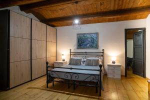 a bedroom with a bed with two night stands and two lamps at colle del mondo country house in Collecorvino