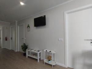 a living room with a flat screen tv on a wall at Villa Ti Neves - Peniche Beach Residence in Peniche