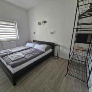 a bedroom with a large bed and a ladder at Vila Natasa Apartment 5 near Plitvice in Vrhovine