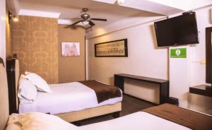 Postel nebo postele na pokoji v ubytování Hotel Clara Luna