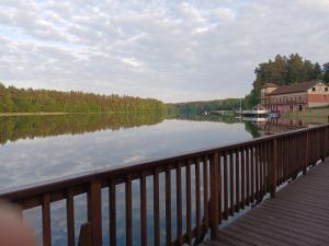 a view of a lake from a wooden bridge at Bajkowy Dom in Mielno
