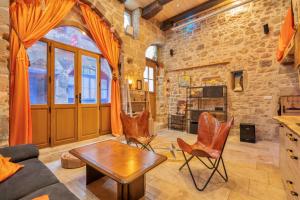 a living room with a table and chairs at Cassiopée in Figeac