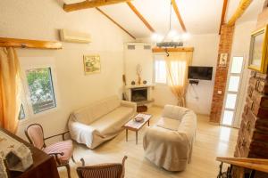 a living room with a couch and a table at Kamera House - 10 min to Seitan Limania Beach in Khordhákion