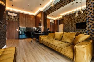 a living room with a couch and a kitchen at Stegna Gold Amber Apartment in Stegna
