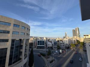 a view of a city with buildings and a street at 2 BR apartment in the Limassol with sea view in Limassol +3 photos