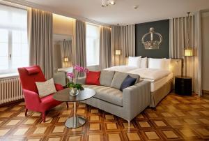 pokój hotelowy z łóżkiem i kanapą w obiekcie Sorell Hotel Krone w mieście Winterthur