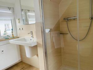 a bathroom with a shower and a sink at Stuv Mariken - Apartment in Warnemünde in Rostock +22 photos