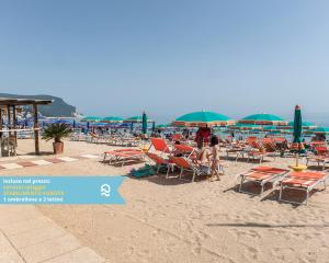 een groep stoelen en parasols op een strand bij RS317 - Marcelli, bilocale in residence fronte mare in Marcelli