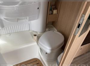 a small bathroom with a toilet and a sink at Camper Van 2018 Fiat capron A72 model in Reykjavík +9 photos