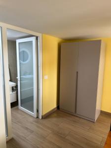 an empty room with a door to a bathroom at Auto Tana Guest House in Tirana