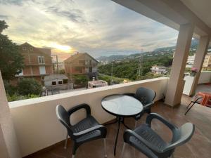 a balcony with chairs and a table and a view at Belaapartman in Kravlja