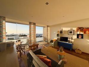 a living room with a couch and a room with a view at Gelfa SEAcrets in Caminha