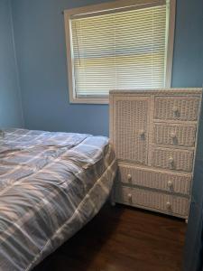 a bedroom with a bed and a dresser and a window at Lakeview Retreat at Sunrise Beach in Sunrise Beach