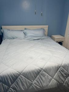 a bed with a white comforter in a bedroom at Lakeview Retreat at Sunrise Beach in Sunrise Beach