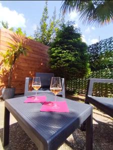 a blue table with two glasses of wine on it at Melody's Garden House -Relax Apartment near Lake Como in Como