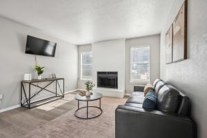 a living room with a couch and a fireplace at The Chandler 1111 I Comfy 2 Bed 2 Bath in Grand Prairie