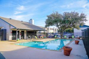 a swimming pool in front of a building at The Chandler 1111 I Comfy 2 Bed 2 Bath in Grand Prairie