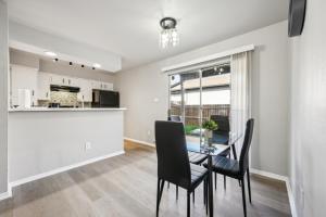 a dining room and kitchen with a table and chairs at The Chandler 1111 I Comfy 2 Bed 2 Bath in Grand Prairie