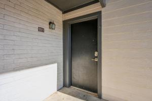 a door on the side of a house at The Chandler 1111 I Comfy 2 Bed 2 Bath in Grand Prairie +13 photos