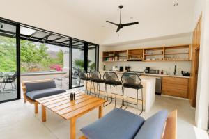 a kitchen and living room with a table and chairs at Casa Guapinol - con vista al Campo de Golf in Tangolunda