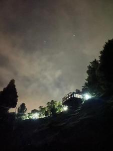 a train is traveling down a hill at night at Cabañas Campestres con jacuzzi - San felix in Medellín